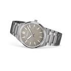 Round steel watch with taupe dial, white hands, date window, and brushed steel bracelet with polished center links, shown at angle.