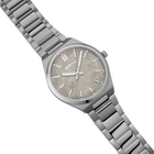 BERING watch with beige dial, applied indices, and steel link bracelet, angled view.