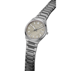 Watch at an angle showing the grey dial with indices and metal link bracelet.