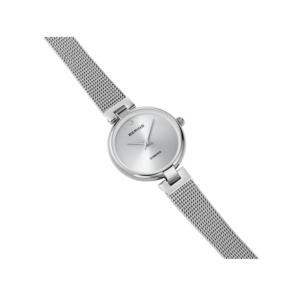 Silver BERING wristwatch with round dial and mesh bracelet, positioned diagonally on white background.