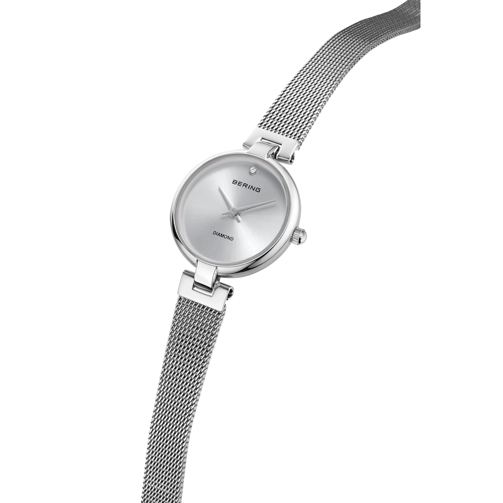 BERING wristwatch with silver dial and woven mesh band, angled view of watch face and bracelet