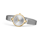 Round watch with silver dial, gold case details, and steel mesh strap, shown at an angle.