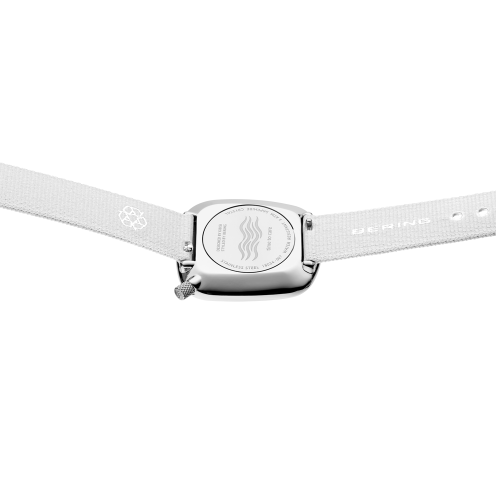 Round watch face in square case viewed from above, light textile strap with perforated edges