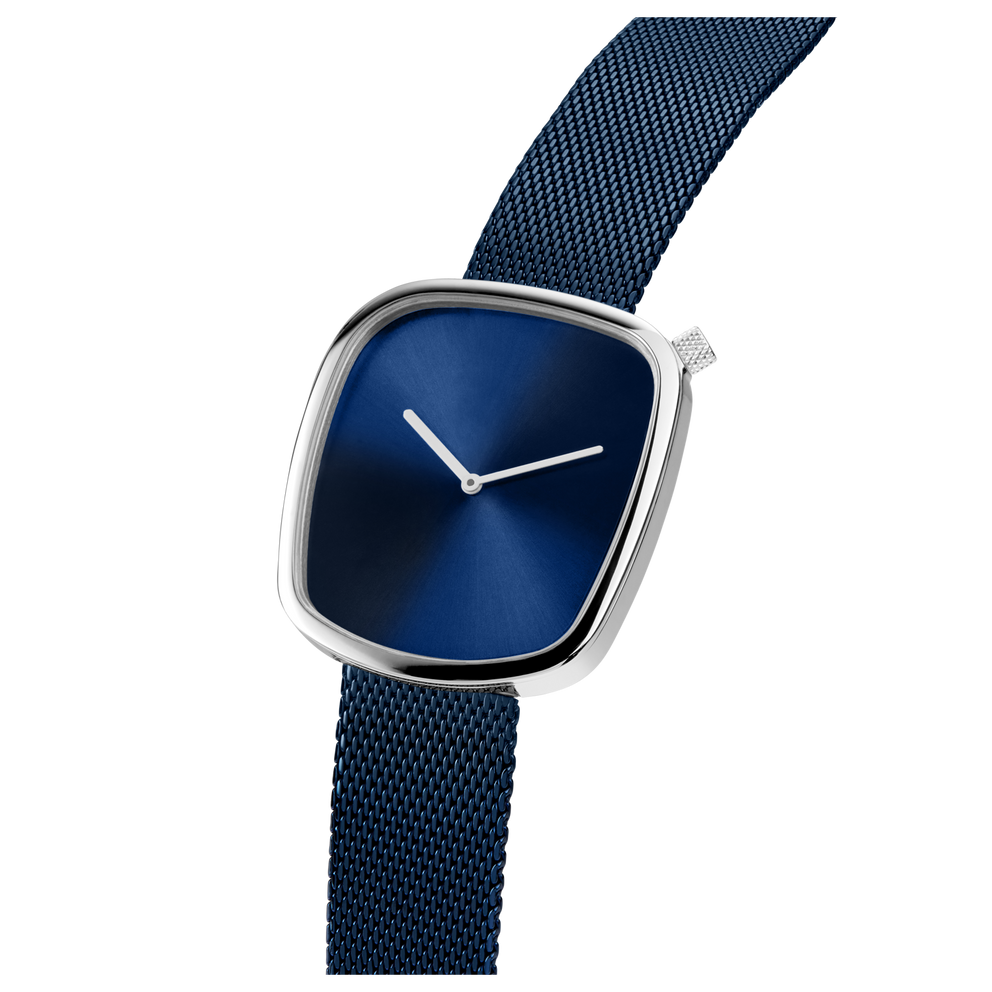 Watch shown at side angle with square silver case, dark blue dial, white hands, and dark blue textured fabric band.
