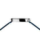 Silver watch case with blue woven fabric straps, viewed from above at an angle