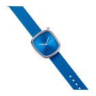 Blue wristwatch with square case, white hands, and textured blue fabric strap with white perforations