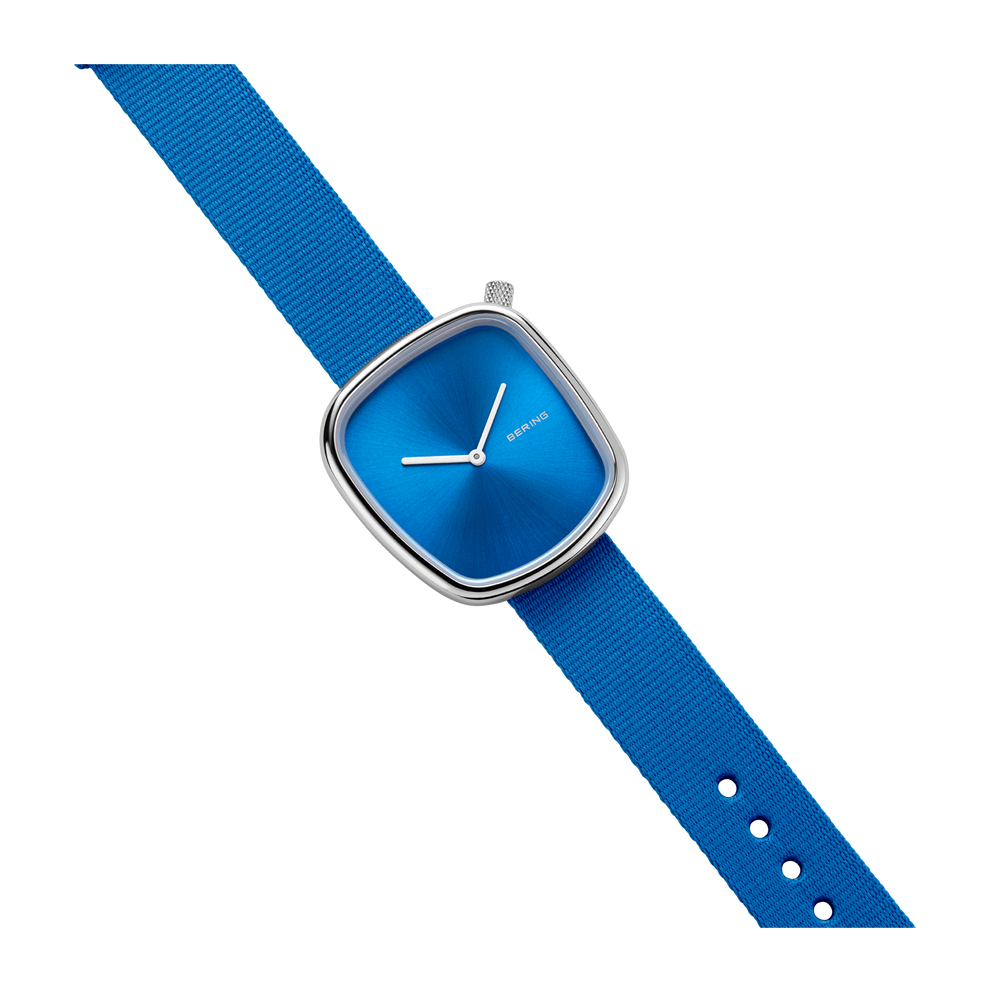 Blue wristwatch with square case, white hands, and textured blue fabric strap with white perforations