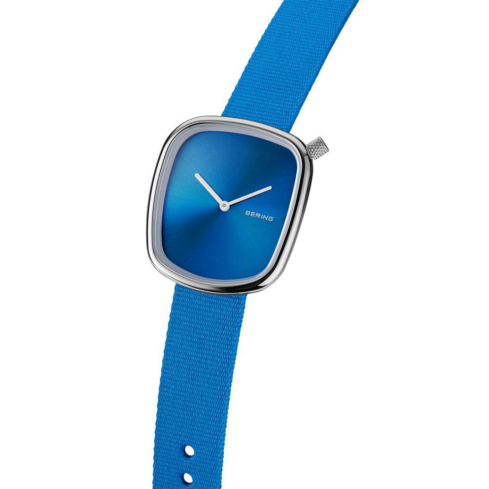 Square watch with blue dial, silver case, and blue textile strap