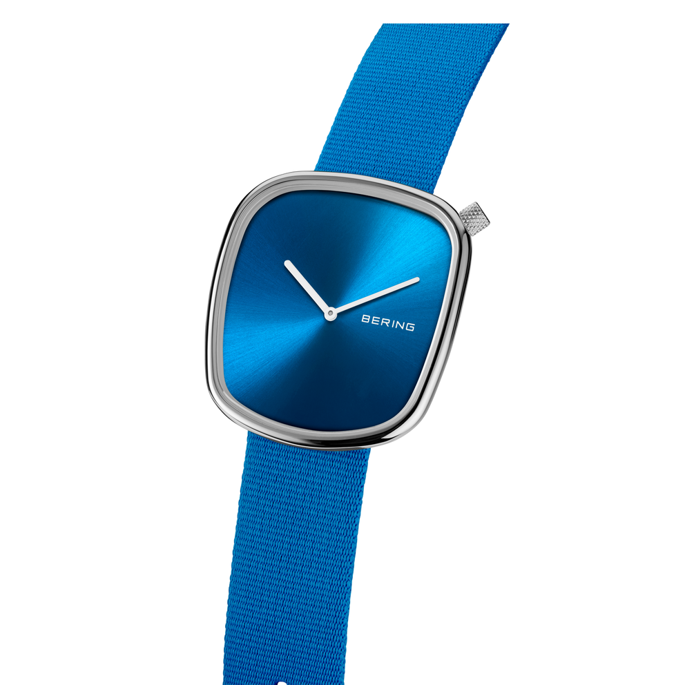 Watch with blue square dial and blue strap, side-angle view