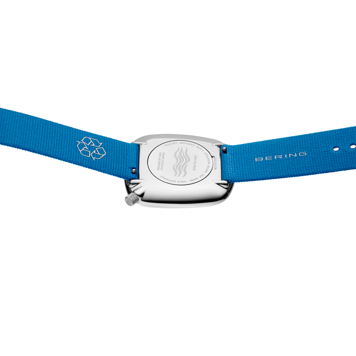 Rectangular silver watch case with blue textile strap, detail view of case and crown