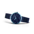 Blue-cased watch with dark dial and mesh band, angled detail view
