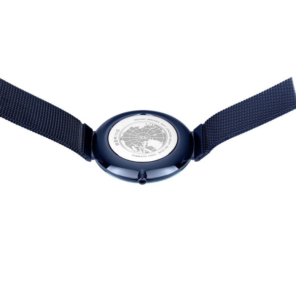 Dark blue watch case with white dial and dark blue fabric straps, top view