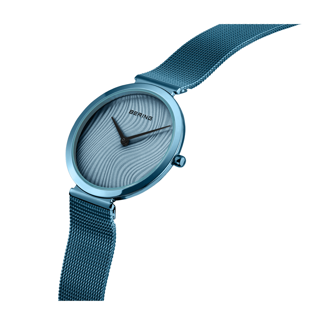 Teal mesh-band wristwatch with grooved dial, angled view
