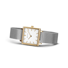 Square-cased wristwatch with rose gold accents, white dial, black hour markers, and gray mesh band.