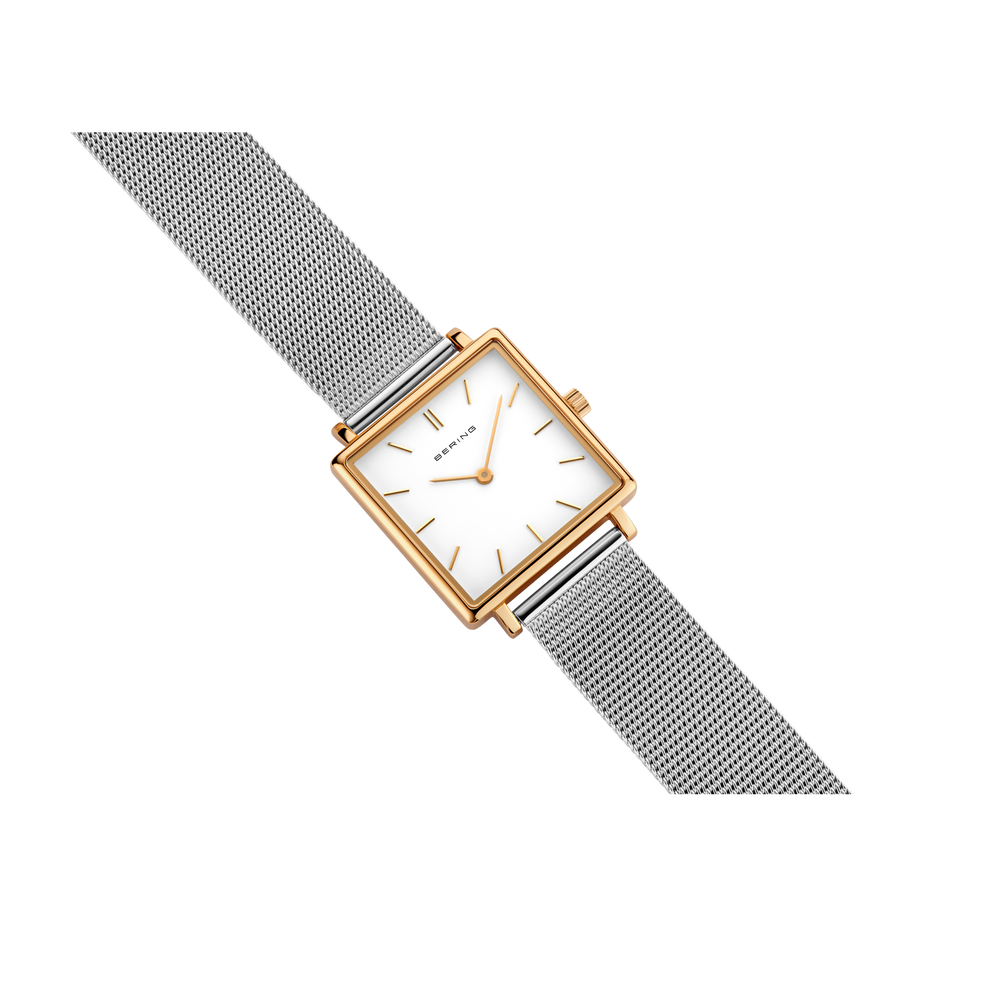 Square rose-gold watch case with white dial and gray textured band, displayed at an angle.