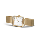 Square gold-tone watch with white dial and mesh bracelet, angled view of case and band