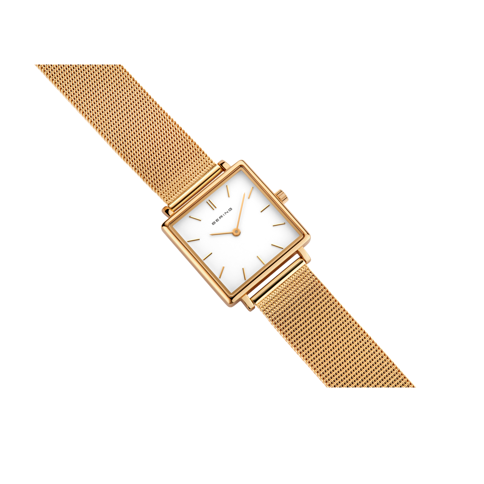 Gold-toned square watch with mesh metal band, displayed at an angle.