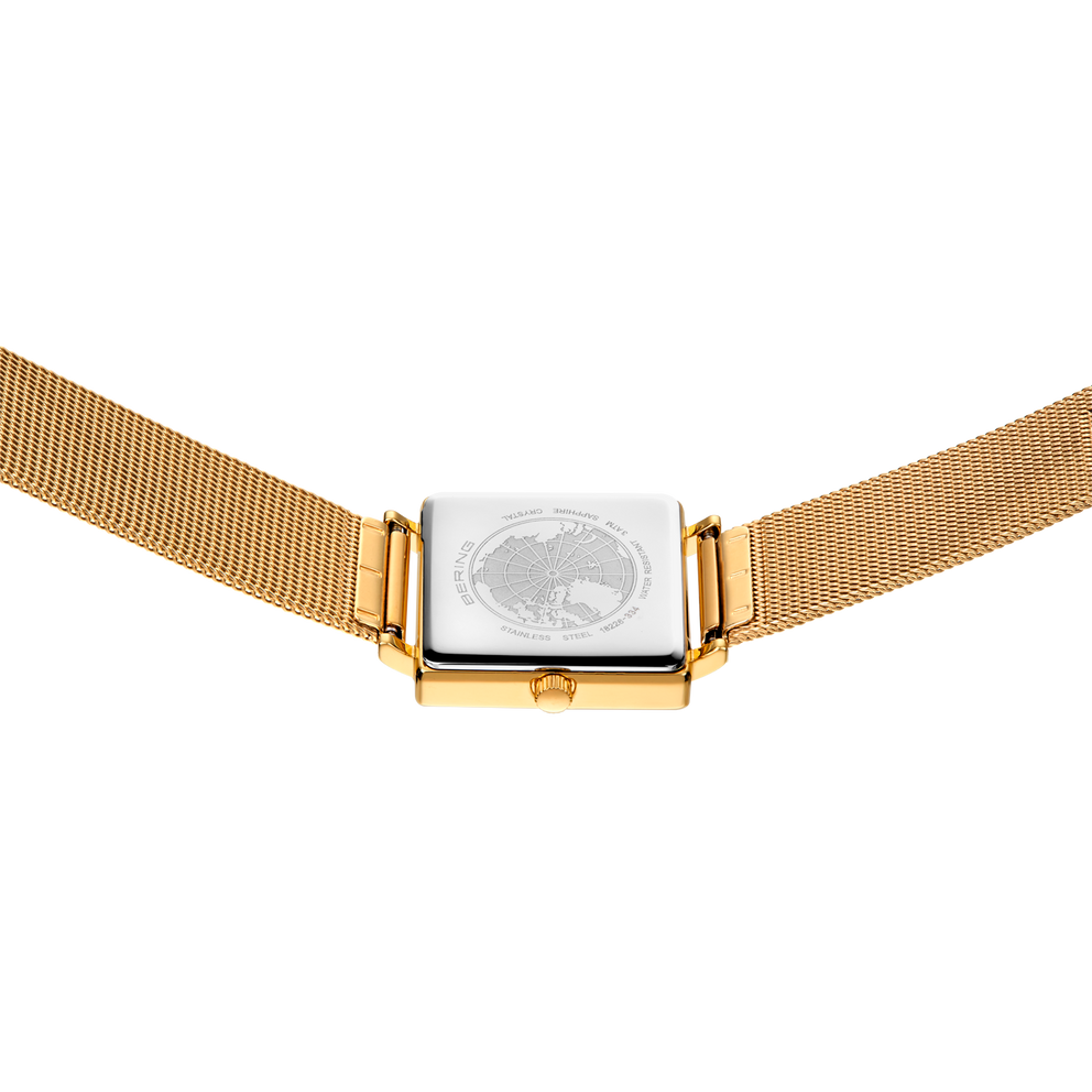 Watch viewed from below, showing gold mesh band and rectangular case with globe-patterned dial.