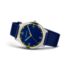 Wristwatch with dark blue dial, gold bezel, and dark blue textile strap, shown at three-quarter angle.