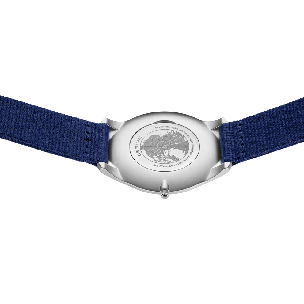 Silver BERING watch with blue textile strap, back view
