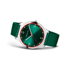 BERING watch with teal dial, red accent ring, silver case, and green textile straps, angled side view
