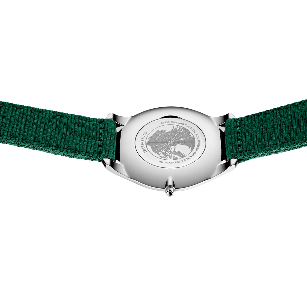 Silver-cased wristwatch shown from the back, with round dial and forest green textile strap.