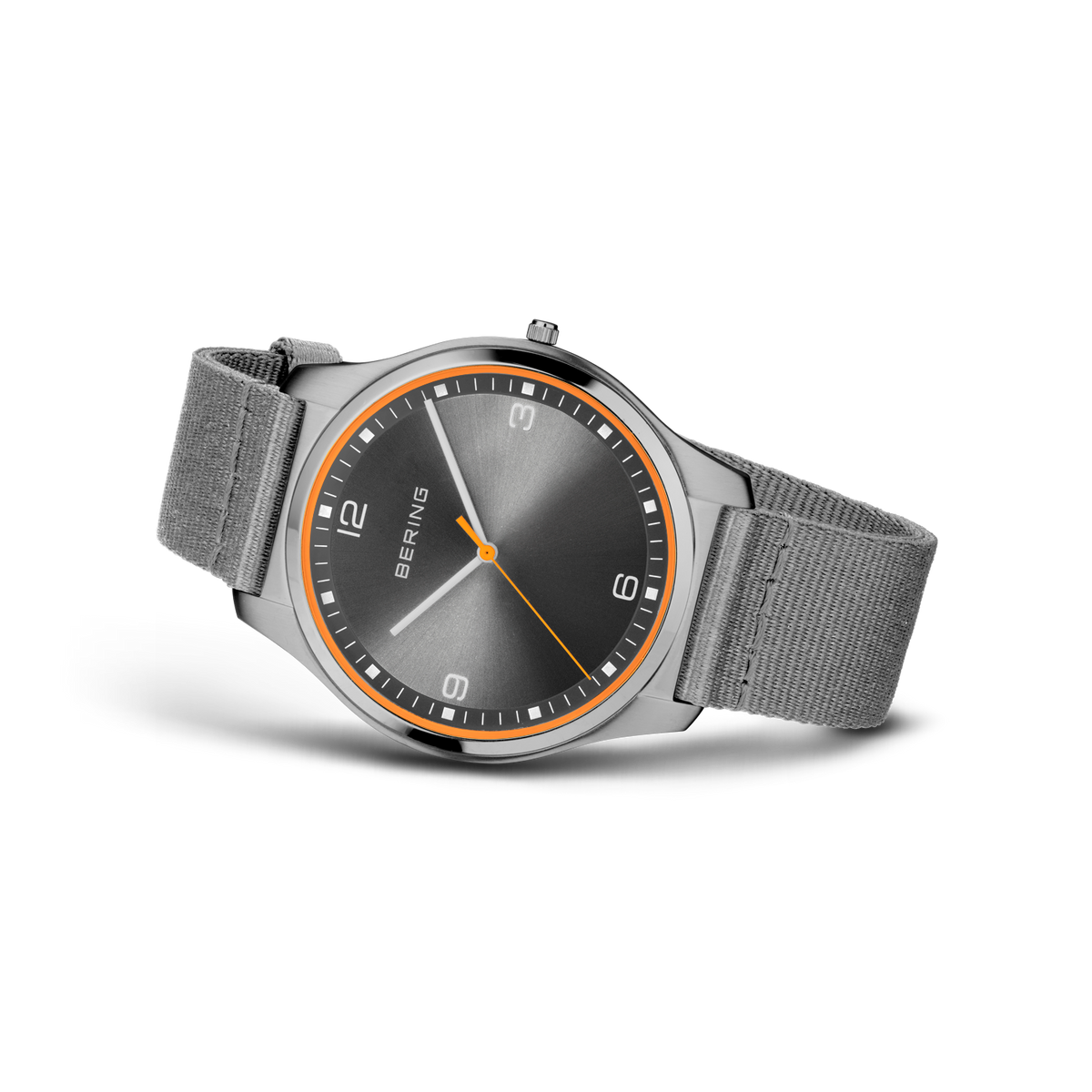 Three-quarter view of round black dial with orange bezel, Arabic numerals, and gray fabric strap.