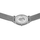 Watch caseback with transparent back showing internal mechanism, grey mesh band