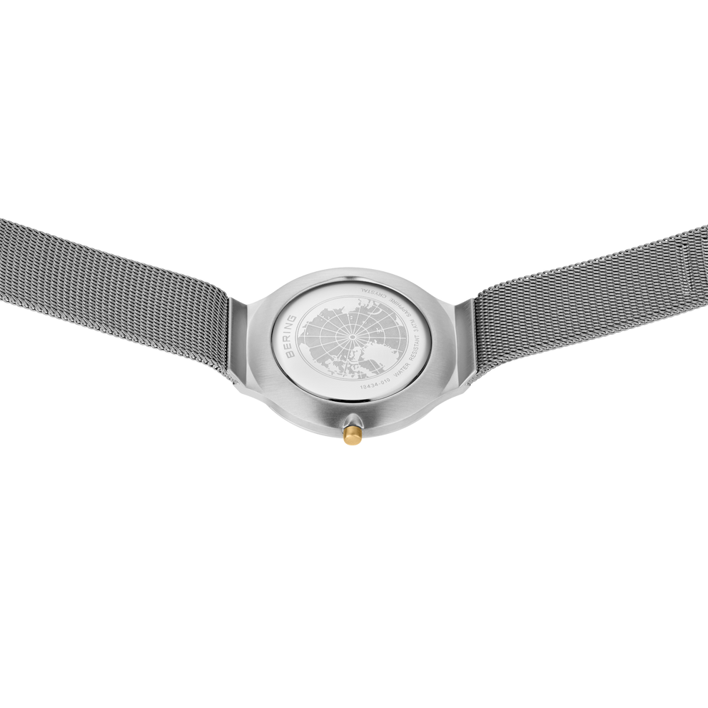 BERING wristwatch 18434-010 frontal view with round case, light dial, extended mesh band, and gold crown detail.
