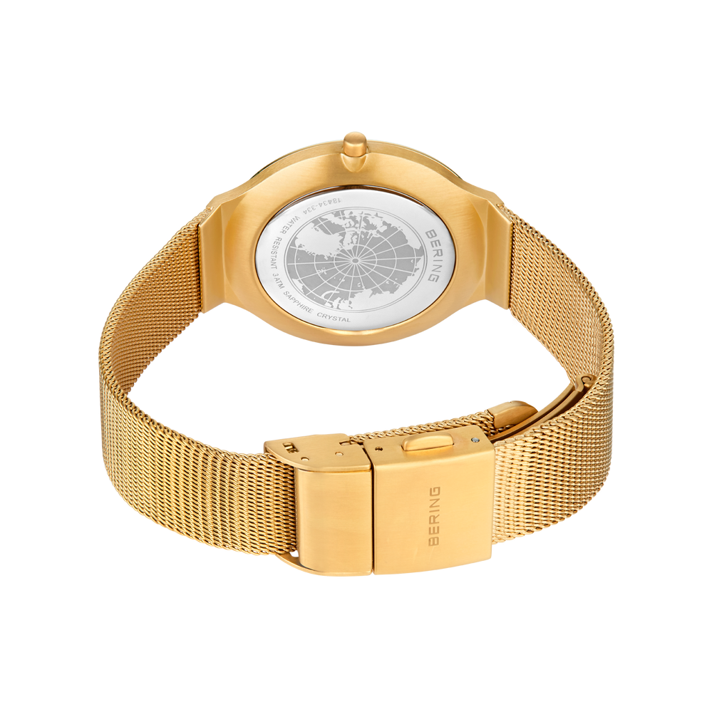 Orologio con cinturino mesh dorato e quadrante strutturato, vista posteriore con chiusura a clip