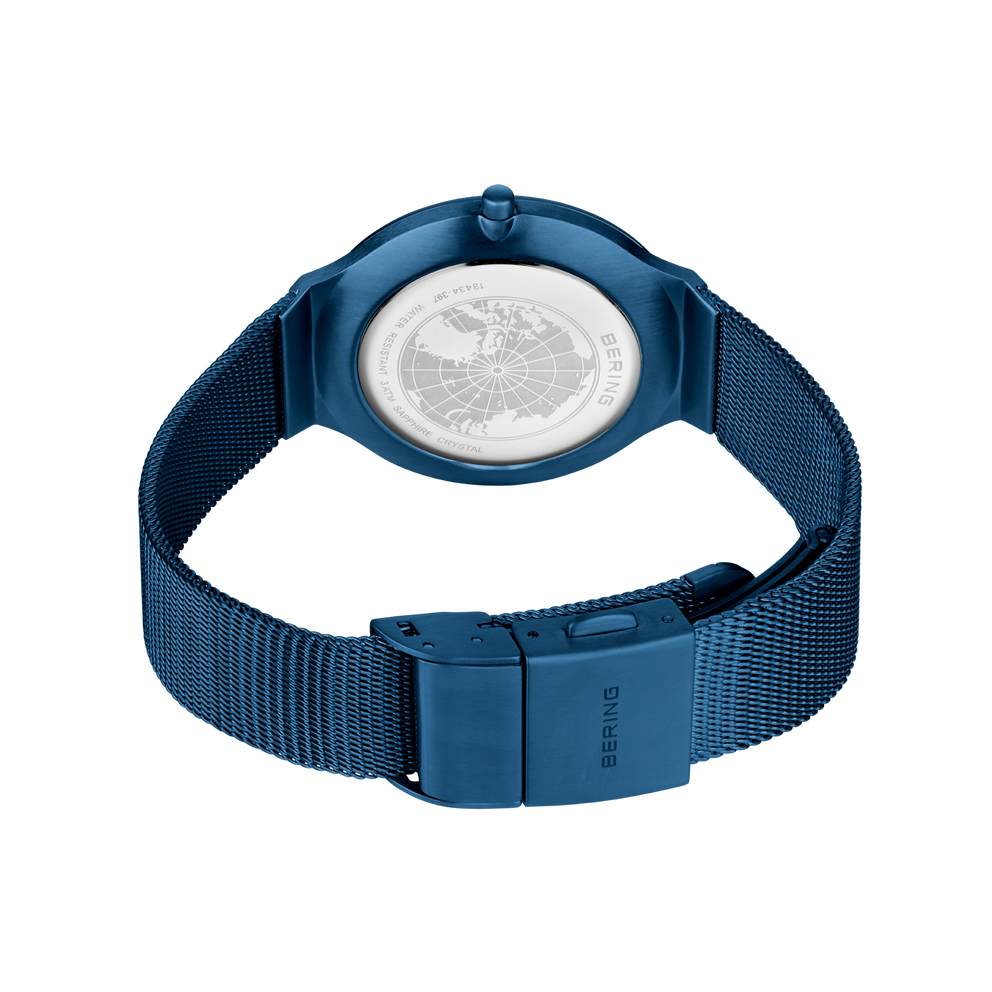 Back view of BERING watch with dark blue mesh band, showing metal clasp fastening