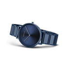 Dunkelblaues rundes Zifferblatt mit weißen Stundenindizes und dunkelblaues Metallarmband, seitlich fotografiert.