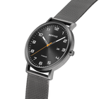 Black-dial BERING titanium watch with white hour markers, white and orange hands, shown at angle with mesh metal bracelet.