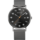 Black-dialed BERING wristwatch with Arabic numerals, orange accent hand, date window, and silver mesh strap.