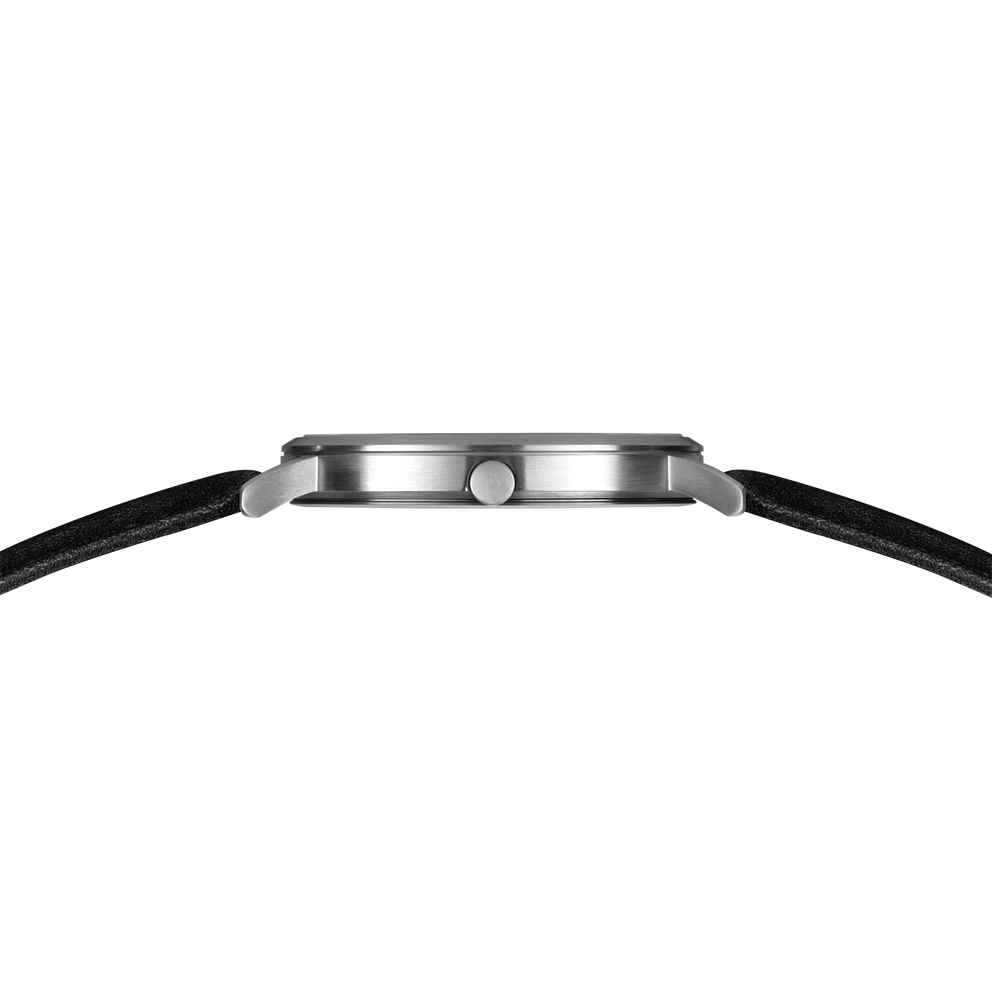 Watch side profile showing brushed steel case and black textured strap.