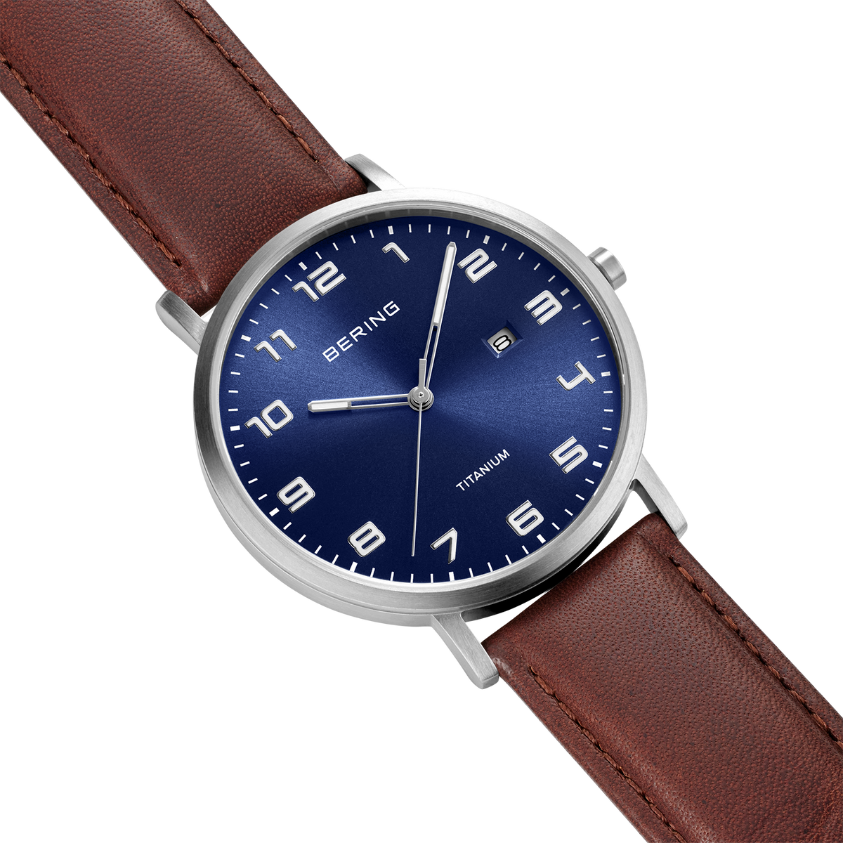 BERING wristwatch with navy blue dial, silver case, white markers, and brown leather strap on white background.