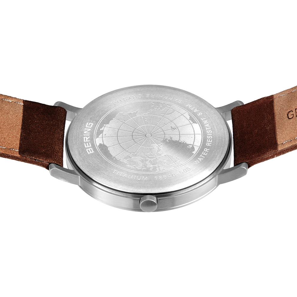Watch caseback with brown leather strap and tan stitching detail