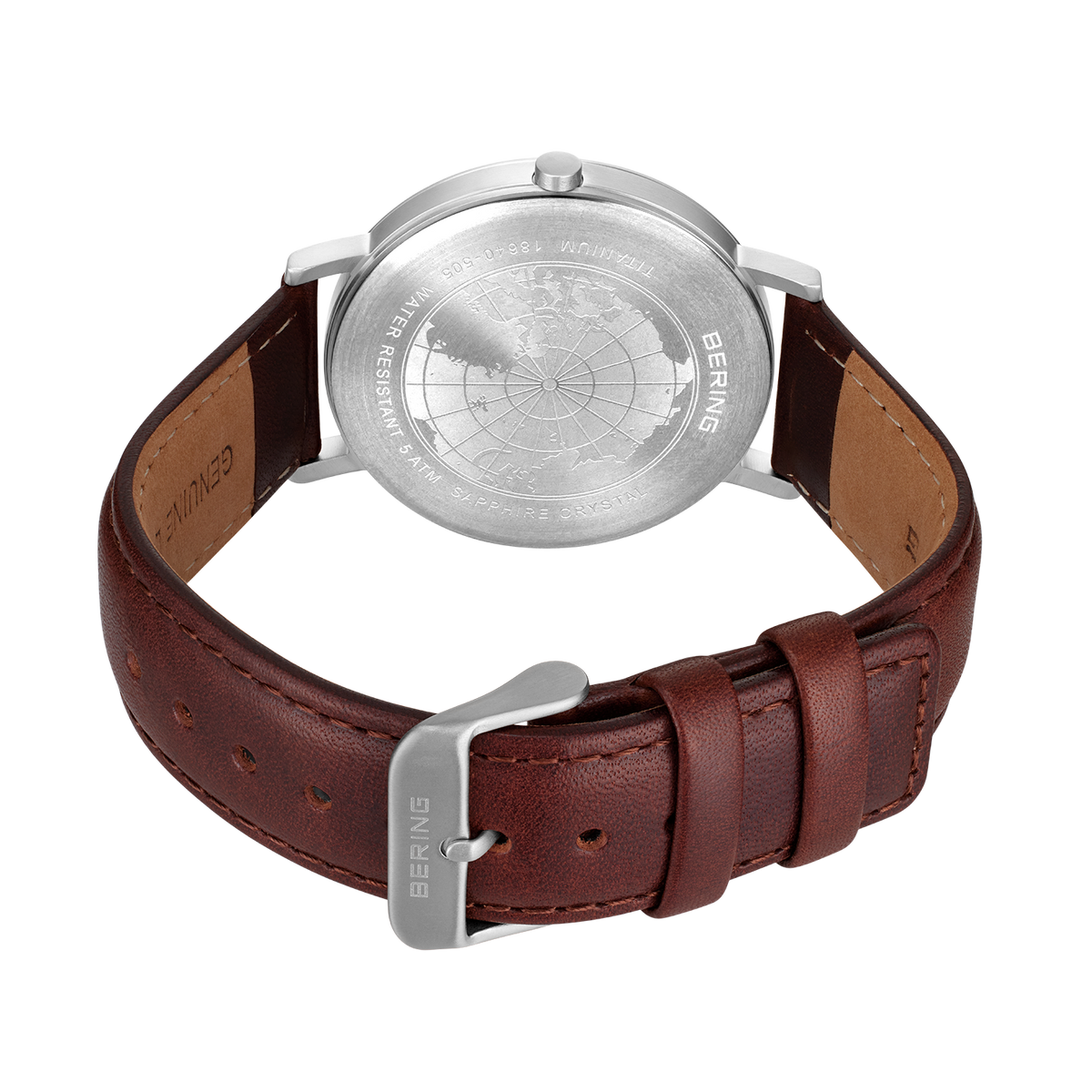 Watch shown from back with engraved silver caseback, brown leather strap, and metal buckle.