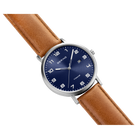 BERING round watch with silver case, navy dial, and brown leather strap shown at an angle