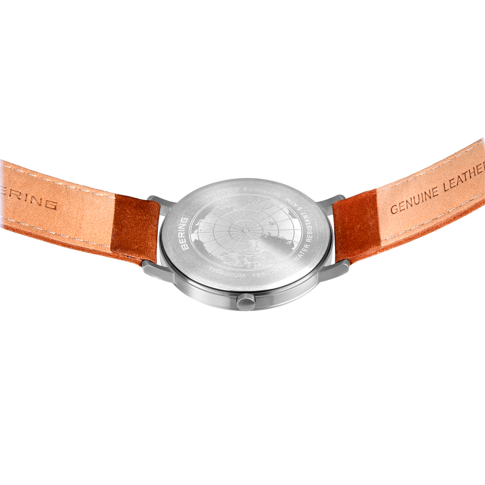 Back view of BERING wristwatch with cognac leather strap; "BERING" embossed left, "GENUINE LEATHER" embossed right.