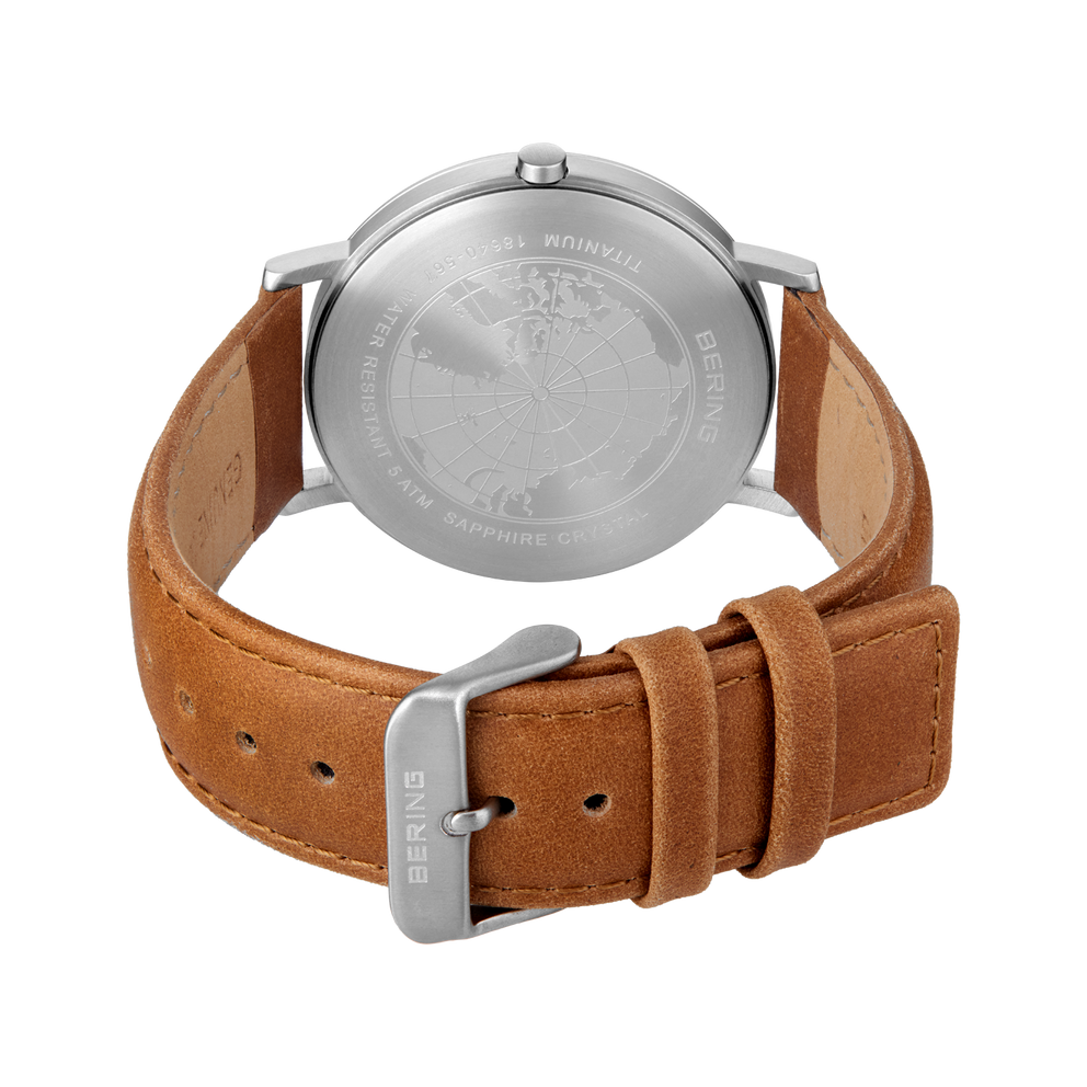 Watch caseback and brown leather strap with silver buckle, shown from rear
