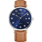 BERING watch with navy dial, white Arabic numerals, date window, silver stainless steel case and tan leather strap.