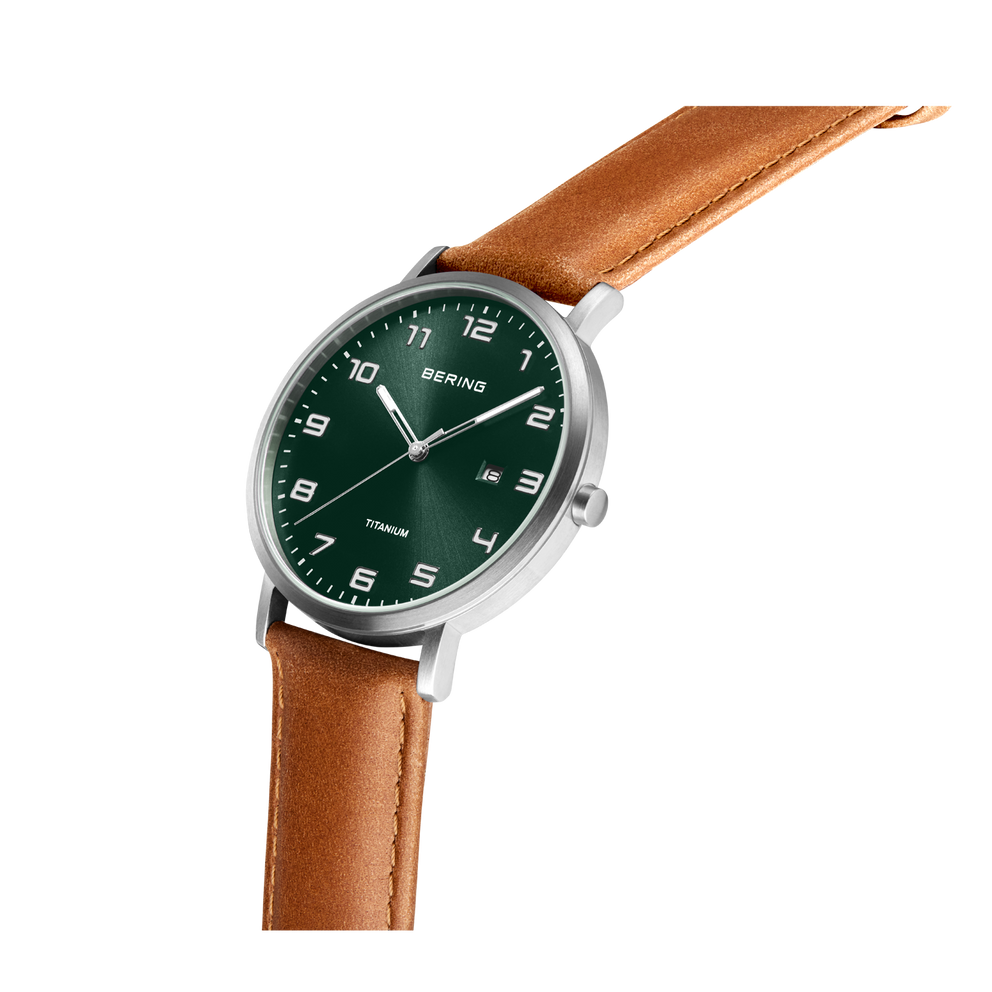Watch with dark green dial, silver case, and brown leather strap, shown at an angle