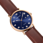 BERING wristwatch with navy dial, rose gold case, and burgundy leather strap, shown at three-quarter angle.