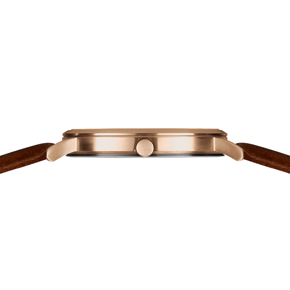 Watch side profile with rose gold case, dark dial, and brown leather strap