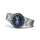 BERING wristwatch angled to show silver bracelet, dark blue dial with luminous indices, blue bezel, and blue hands.