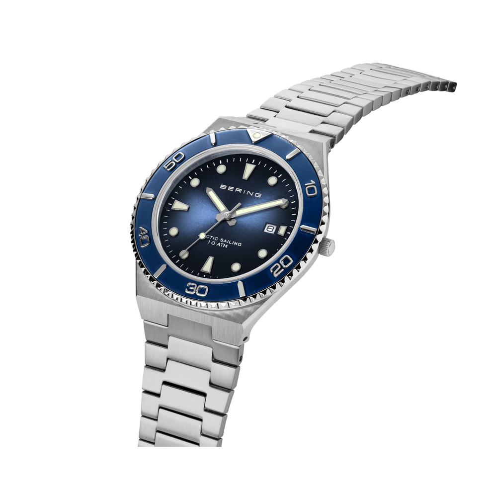 Silver-link bracelet and dial detail of BERING wristwatch with blue bezel